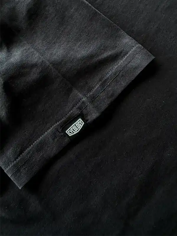 Black cycling jersey sleeve with CYCLOGY tag, premium fabric detail for men's and women's bike wear