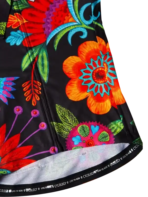 Vibrant floral cycling jersey with bold orange, red, and teal patterns on black fabric