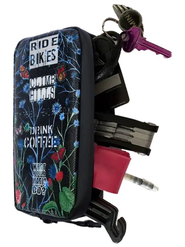 Cycling key organizer with floral print, holds keys, tools, and cards for bike riders