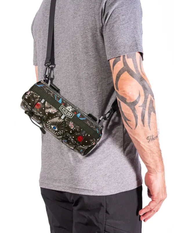 Person wearing a Bicycle handlebar bag with colorful designs and 'Cycology' branding
