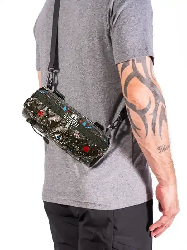 Cycling waist bag with colorful pattern, worn by man with tattooed arm, ideal for bike rides