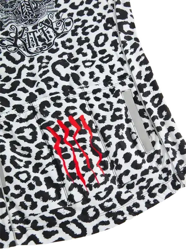 Women's cycling jersey with black and white leopard print, red claw marks, and reflective strip