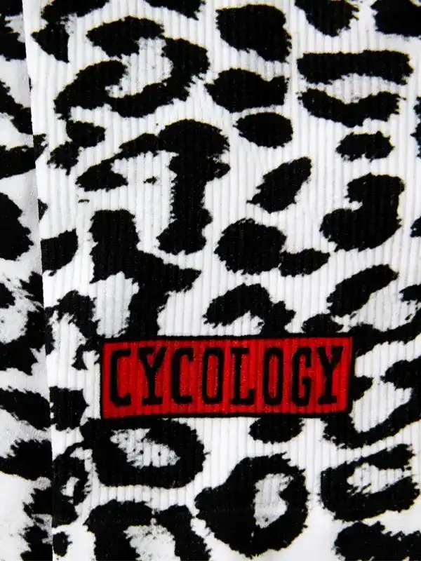 Cycology cycling socks with bold black and white leopard print and red logo patch
