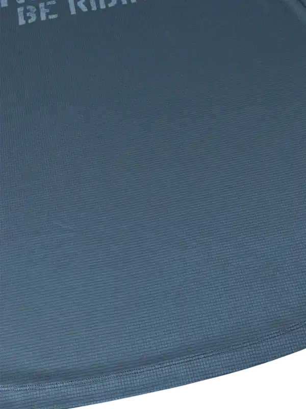 Close-up of textured blue cycling jersey fabric with 'BE RIDE' print, ideal for men's and women's bike wear