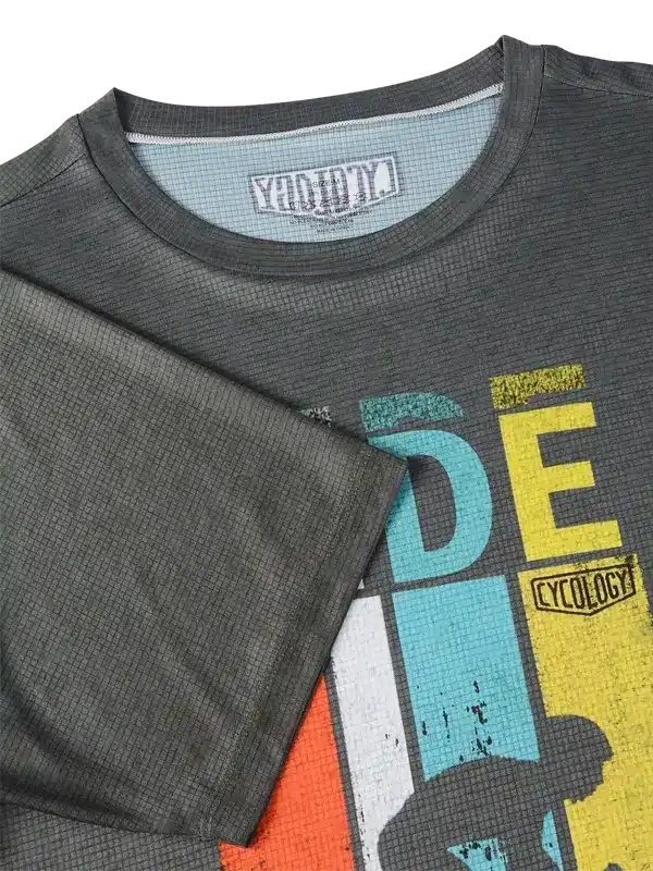 Men's cycling jersey with colorful graphic design and breathable fabric texture