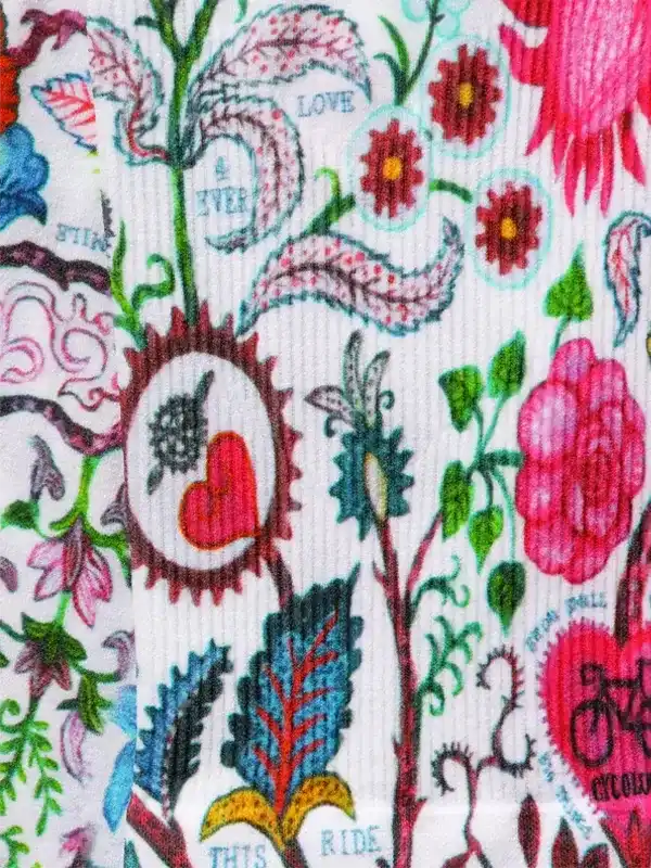 Colorful floral cycling apparel with heart, bike, and 'Love This Ride' design on white fabric