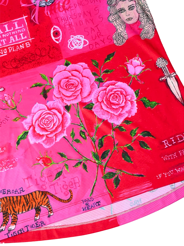 Red fabric with pink roses, a tiger, and text