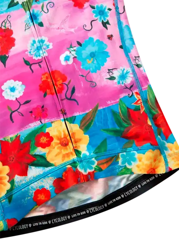 Vibrant floral cycling shorts with pink and blue panels, featuring bold red, yellow, and blue flowers on high-quality fabric.