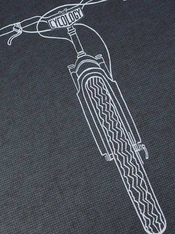 Cycling apparel with white bike graphic on dark fabric, featuring 'CYCOLOGY' on handlebars