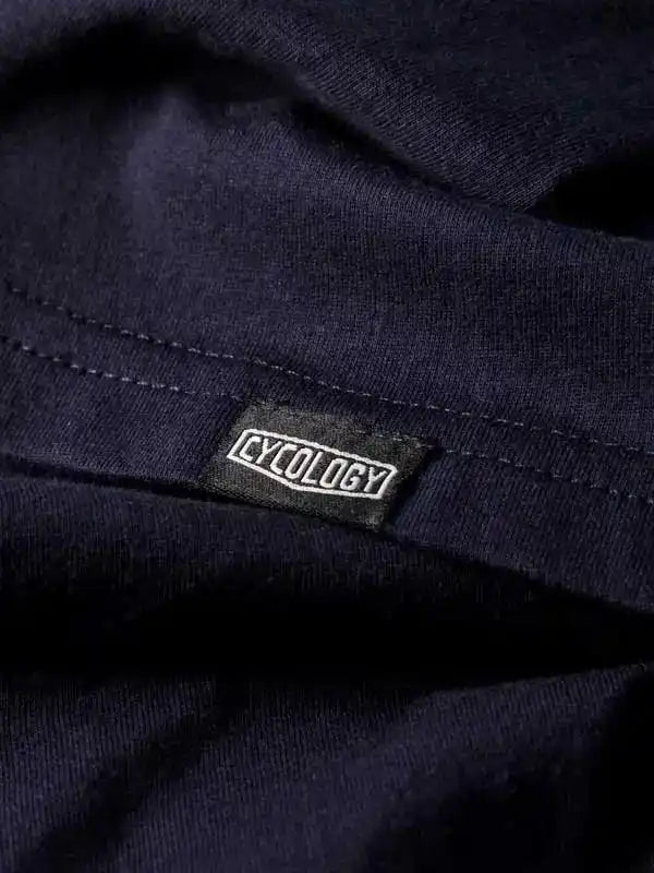 Cycology brand tag on dark navy cycling apparel, showcasing quality fabric and design detail