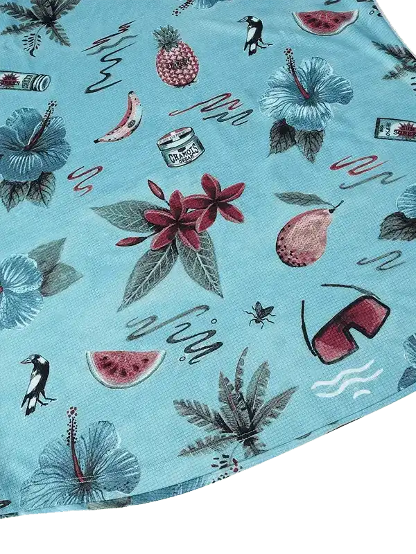 Tropical print cycling jersey with hibiscus flowers, fruit, and birds on light blue fabric