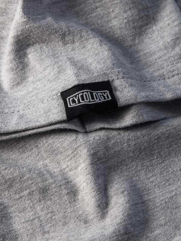 Grey cycling apparel with black Cycology brand tag, soft fabric detail