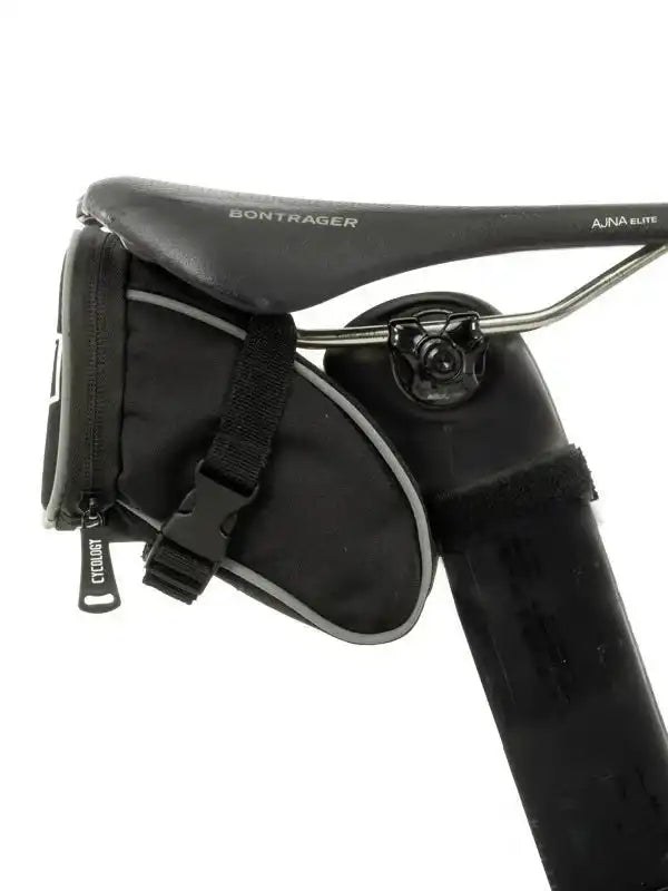 Black cycling saddle bag attached to Bontrager saddle, ideal for bike storage and accessories