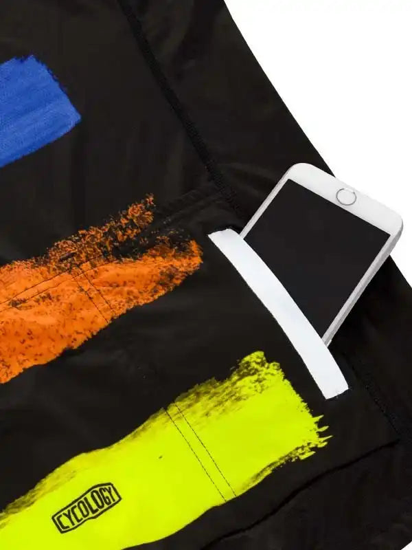 Black cycling jersey with bold neon paint strokes and phone pocket, featuring Cycology logo