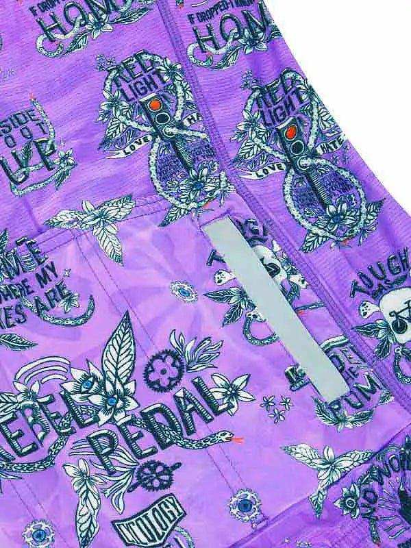 Purple cycling shorts with bold 'Rebel Pedal' print, floral designs, and reflective strip for safety