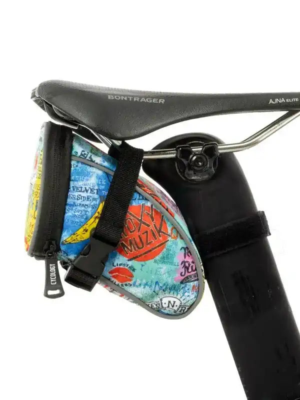 Colorful cycling saddle bag with retro music print, attached to Bontrager bike seat