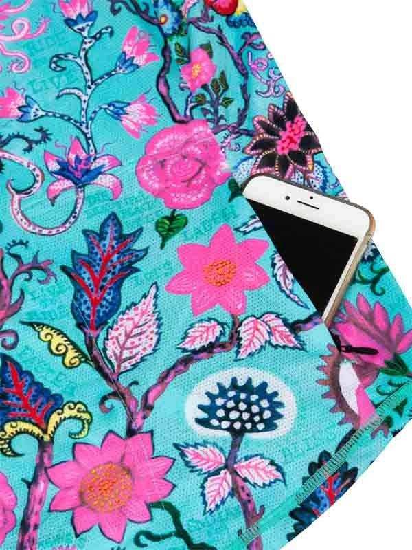 Vibrant floral cycling jersey pocket holding smartphone, turquoise base with pink and blue blooms