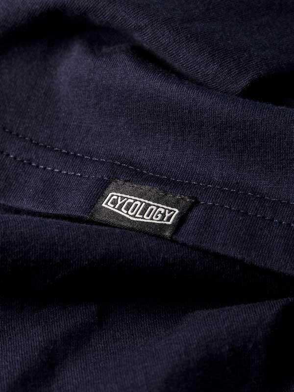 Cycology brand tag on dark navy cycling apparel, showcasing quality fabric and design detail