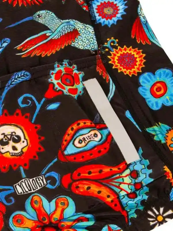 Vibrant cycling shorts with hummingbird, skull, and floral print on black fabric