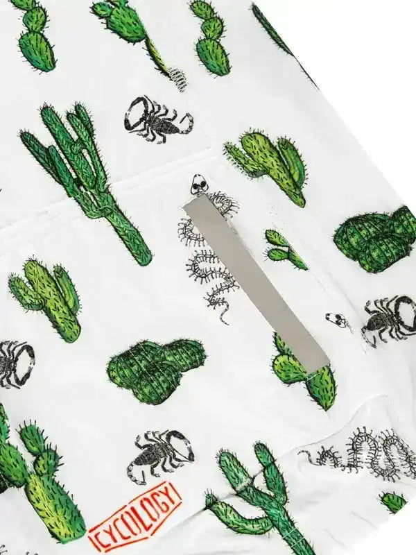 White cycling shorts with green cactus and scorpion print, featuring a rear pocket and Cycology logo