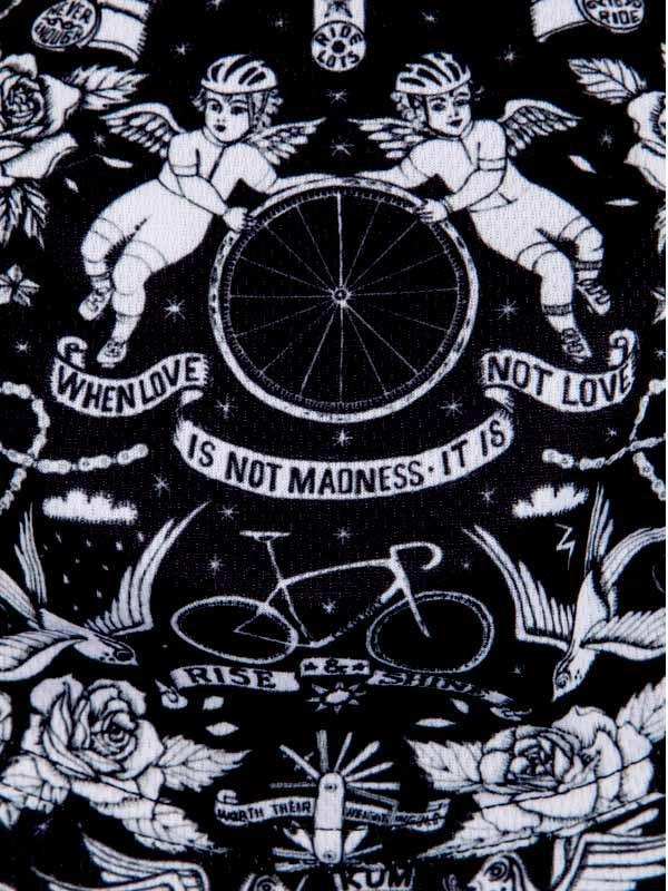 Black and white cycling-themed fabric with angel cyclists, bike wheel, roses, and motivational quotes for cycling apparel.