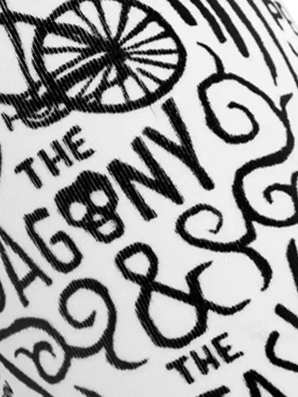 Close-up of cycling apparel with vintage bicycle wheel and 'The Agony' text design