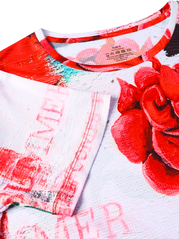 Close-up of a red and white floral shirt with visible branding.