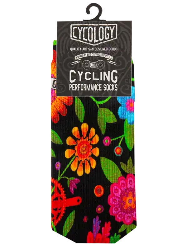 A pair of CYCOLOGY Cycling Performance Socks hanging from a black plastic hanger. The socks feature a black background with a vibrant, colorful floral and gear pattern in orange, pink, green, and red.
