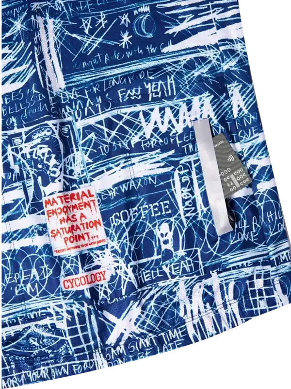 Blue cycling shorts with white graffiti-style print, featuring bold text and Cycology brand patch