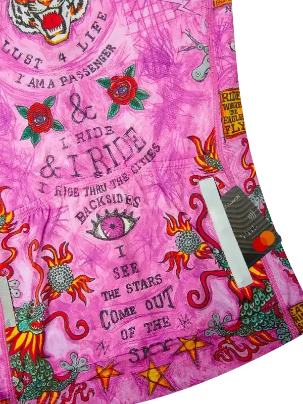 Pink cycling jersey with bold graphics, roses, dragons, and motivational text for road biking