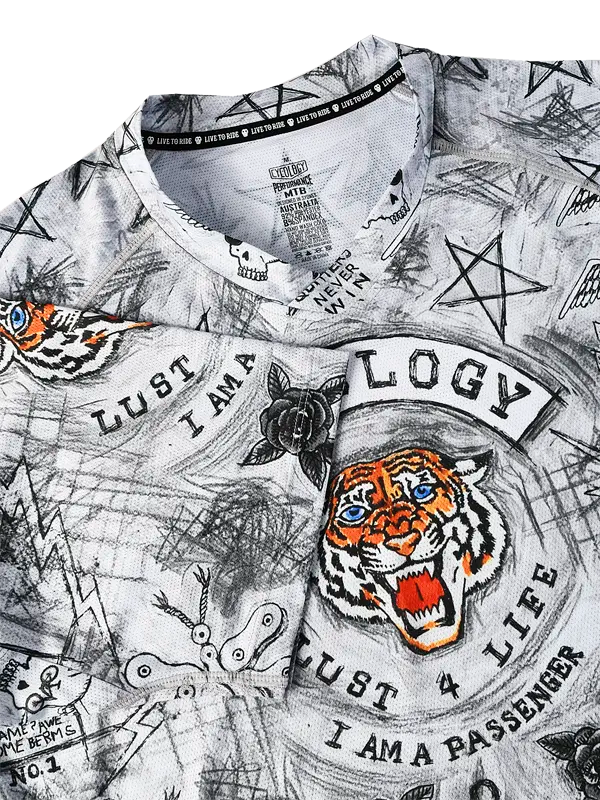 Close-up of a V Neck MTB Jersey with tiger design and text on a light grey background