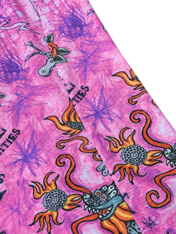 Pink fabric with colorful dragon designs and text 