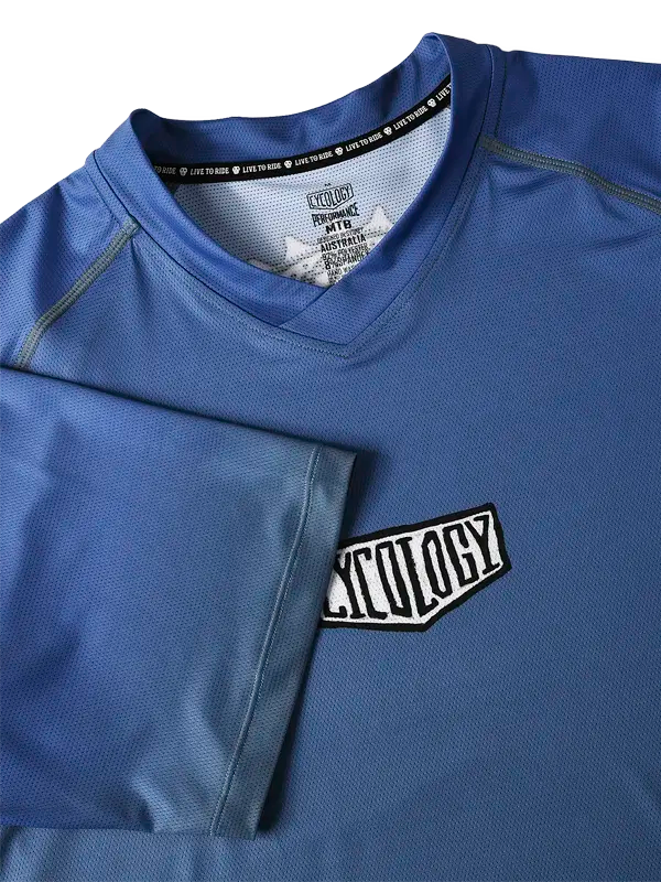 Day of the Shred Navy Men's  Short Sleeve MTB Jersey with a  Cycology brand logo on a blue background