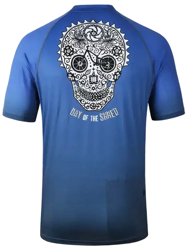 Blue cycling jersey with sugar skull design, 'Day of the Shred' text, and bike wheels detail