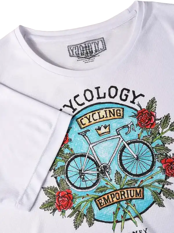 White cycling t-shirt with vintage bike graphic, roses, and 'Cycology Cycling Emporium' print
