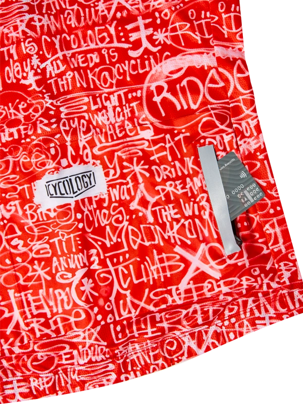 Red men's short sleeve cycling jersey with white text pattern and 'Cycology' branding on back pockets