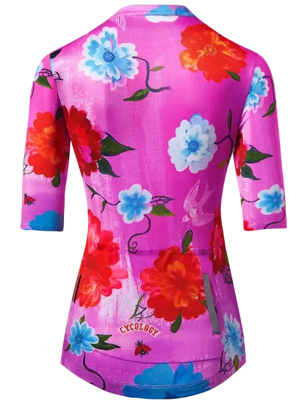 Women's cycling jersey with vibrant pink floral print, blue and red flowers, and ladybugs. Perfect for road biking.