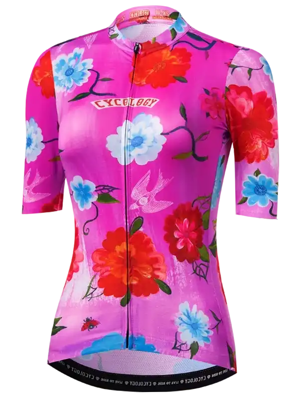 Women's cycling jersey with vibrant floral print, pink base, blue and red flowers, swallow design