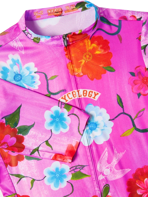 Floral-patterned women's cycling  jersey with colorful flowers on a pink background