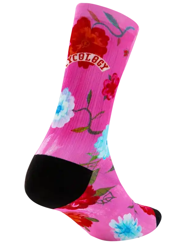 A single crew sock on a white background, featuring a bright pink base with a floral print in red, blue, and white, and a black heel and toe. .