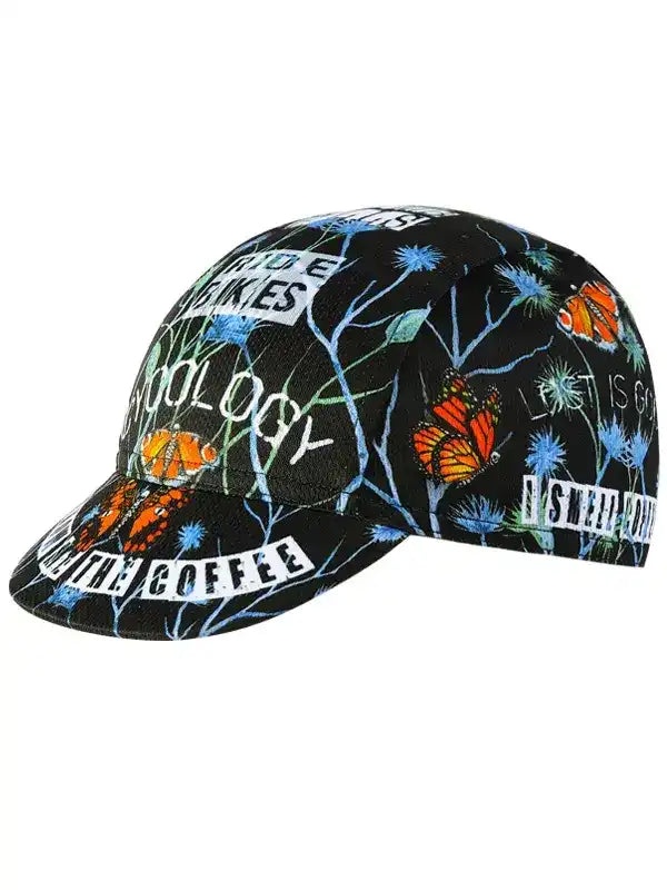 Black cycling cap with butterfly and floral print, featuring 'Ride Makes' and 'Coffee' text for cyclists.