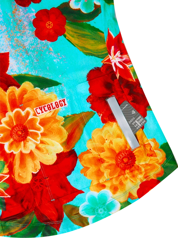 Colorful women's floral-patterned cycling jersey with 'Cycology' branding on a aqua background