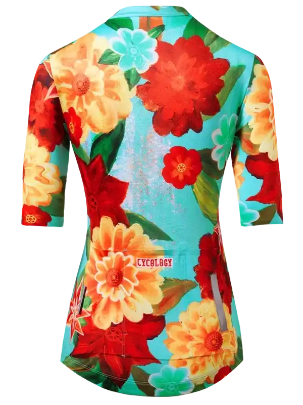 Women's floral cycling jersey with vibrant red, orange, and teal flowers, featuring rear pockets and brand logo.