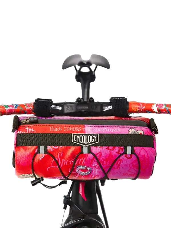 Cycology pink floral bike frame bag with 'Here Comes the Sunshine' print, mounted on handlebars