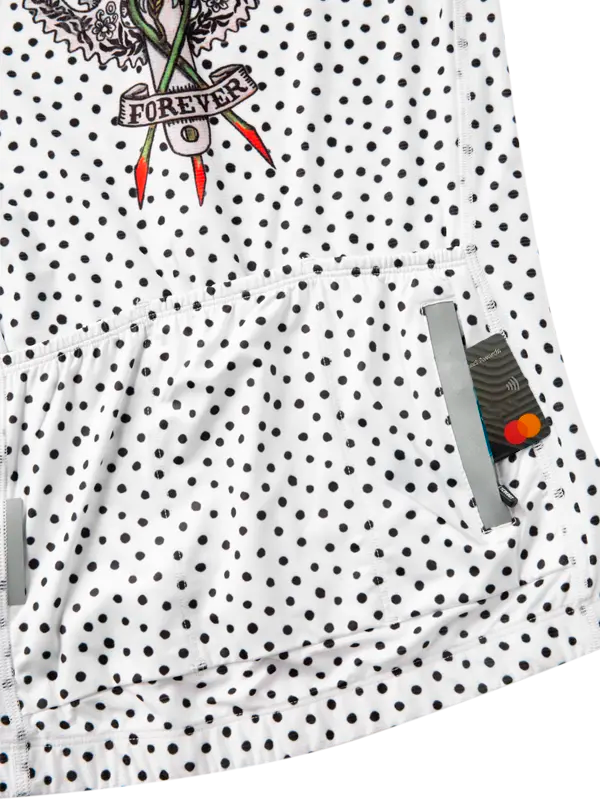 White cycling jersey with black polka dots and a tattoo-style graphic back pockets