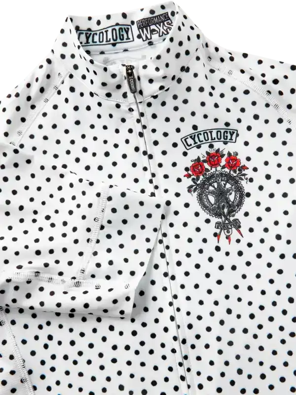 White polka dot cycling jersey with red rose graphic and 'Cycology' logo, performance fabric