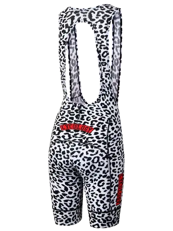 Women's cycling bib shorts with black and white leopard print, red Cycology logo, and ergonomic design