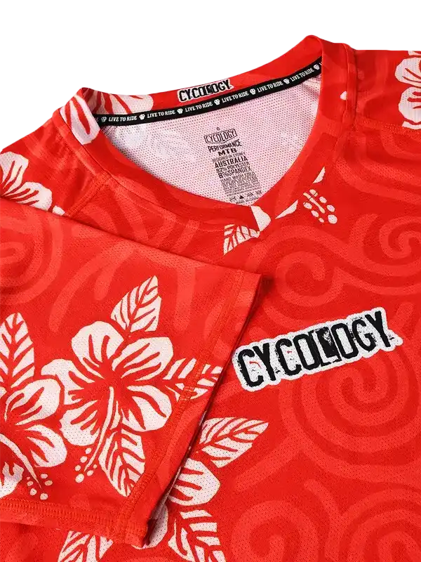Red cycling jersey with white hibiscus print and 'CYCOLOGY' logo, breathable fabric for men's and women's rides