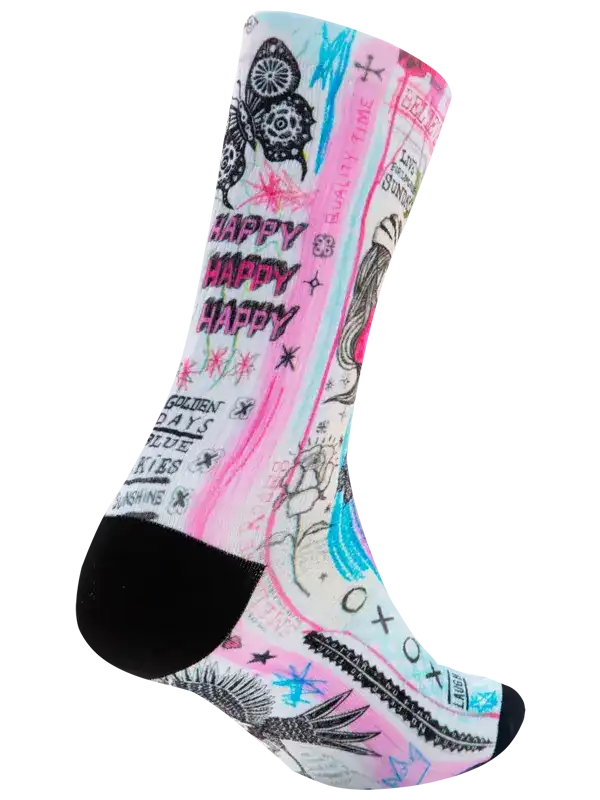 A single crew sock with a vibrant graffiti-style graphic print featuring pink, light blue, black, and white elements, including the words 'HAPPY HAPPY HAPPY' and doodles of a butterfly, face, and cactus, with a solid black heel and toe.