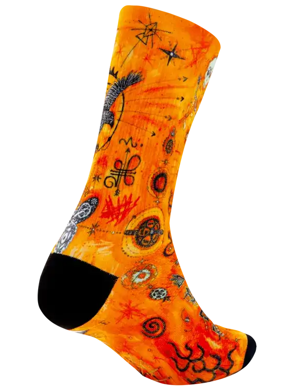 Vibrant orange cycling sock with cosmic and mystical patterns, black toe and heel
